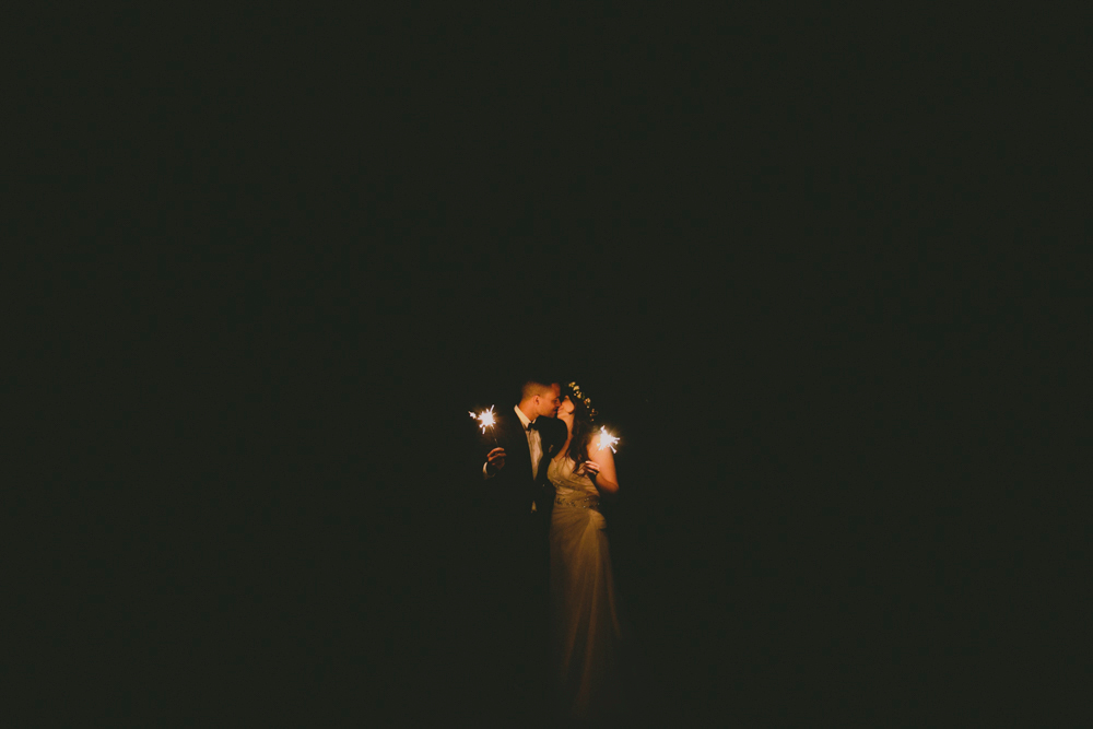 Bride and groom sparklers in the dark